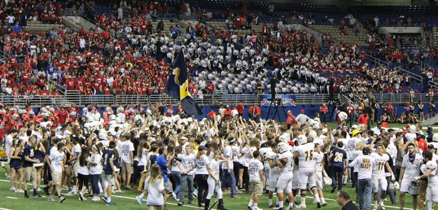 Cy Ranch students storm the field after the football team scores the winning point.