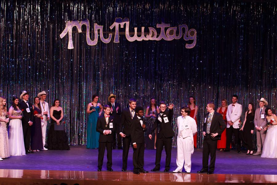 The contestants and their escorts look out into the audience.