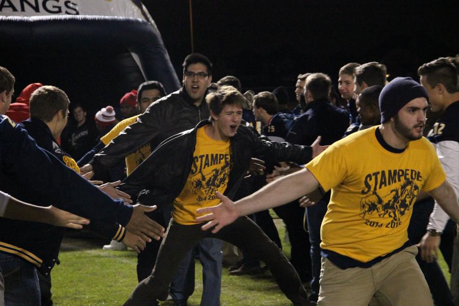 The Stampede celebrates on the football field.