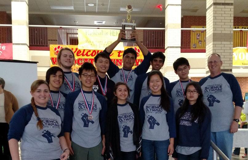 The Science Olympiad team along with adviser Justin Powers poses with their third place trophy.