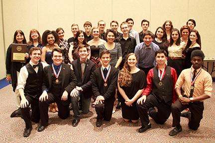 The winning cast poses with their medals following their win.