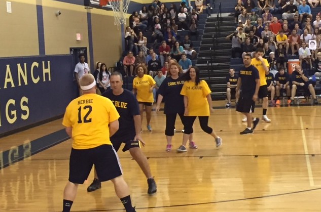 The faculty faces off in the basketball game held in Riles' honor.