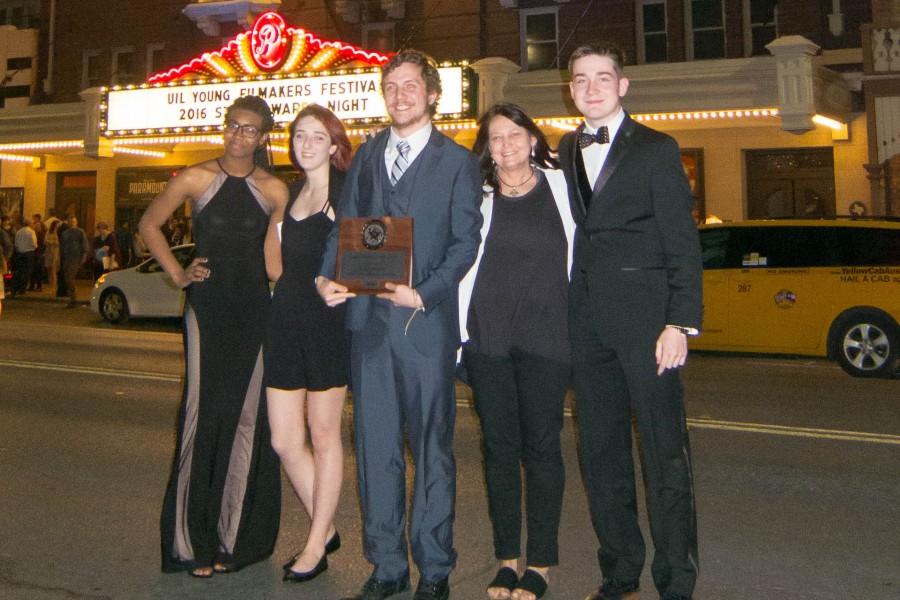 From left to right: Alexandria Dave, Daryn Crowninshield, Brett Bellamy, Coach Bradford, and Cole Andrews pose with their award in front of the Paramount Theatre in Austin, Texas.