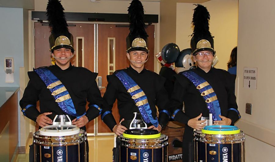 The three students posed inside the hospital hallway before beginning their performance. 