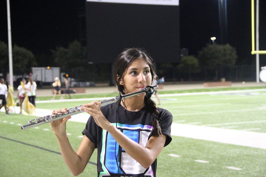 Junior Alicia Piper, one of the All State band inductees, playing the flute. 