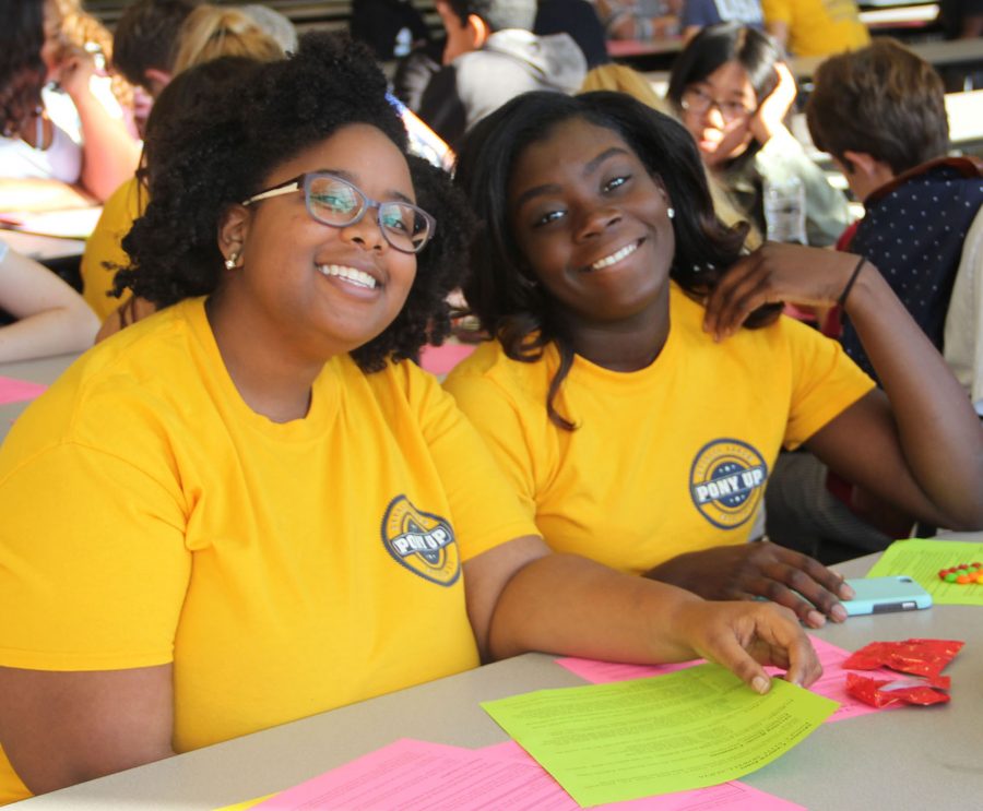 Senior Pony Up mentors, Camryn Jones and Genesis Smothers, pose for a photo while talking through their discussion topics.