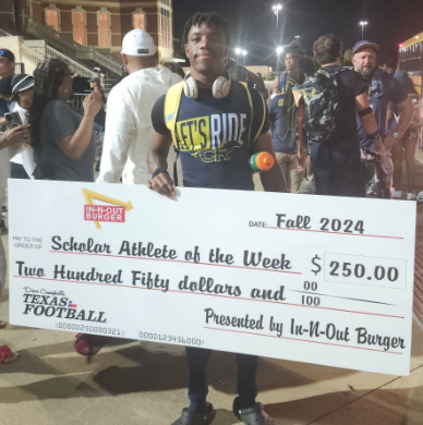 Senior Brendan Sadler holds an award after the Sept. 20 varsity football Homecoming game vs. Cypress Springs at the Berry Center.