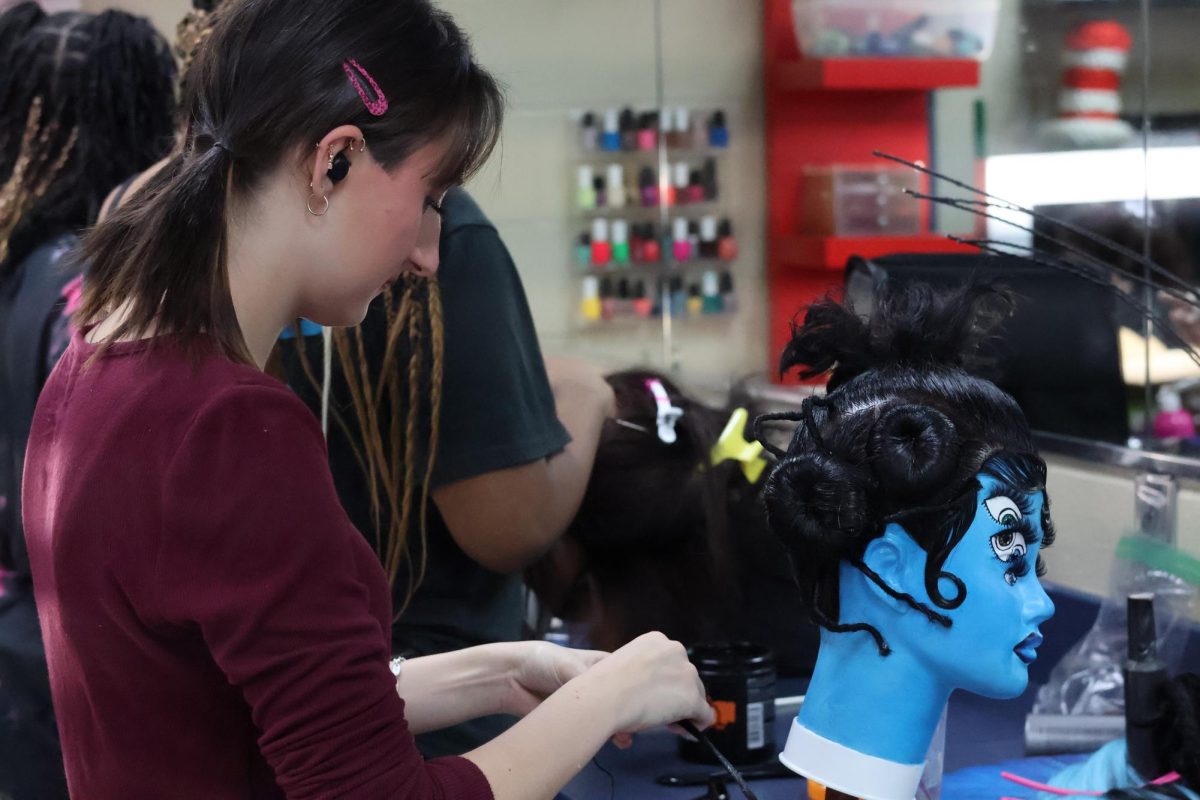 Mykie Posik works on styling hair during her cosmetology class for Skills USA on Jan. 29.