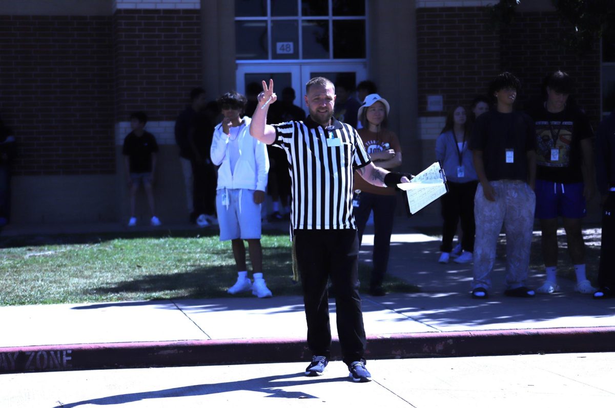 Alan Richards referees the annual Geometry Dash on Oct. 15, 2025. The Geometry Dash allows students to practice their math skills.