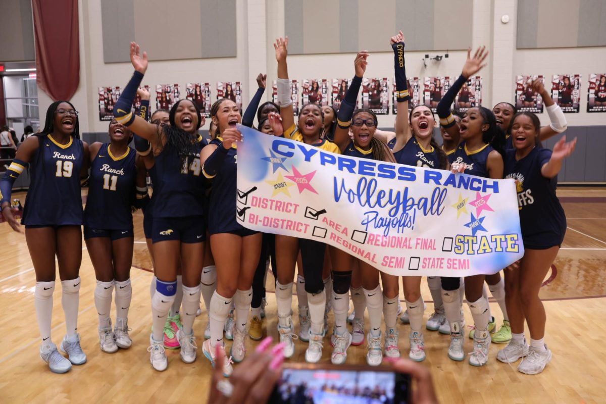 Cypress Ranch volleyball celebrates after winning a playoff game against The Woodlands.